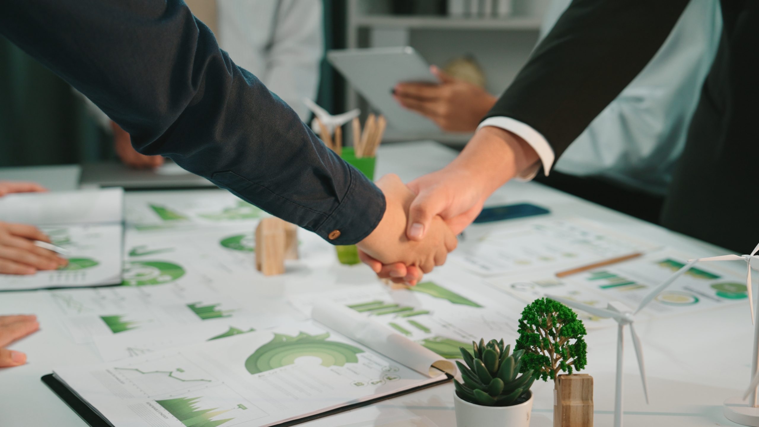 two,business,professionals,engage,in,a,handshake,signaling,agreement,over