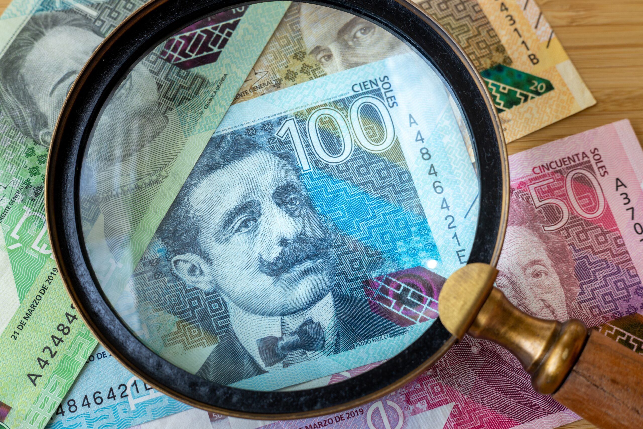 peru,money,and,magnifying,glass,,finance,and,economic,concept,,close