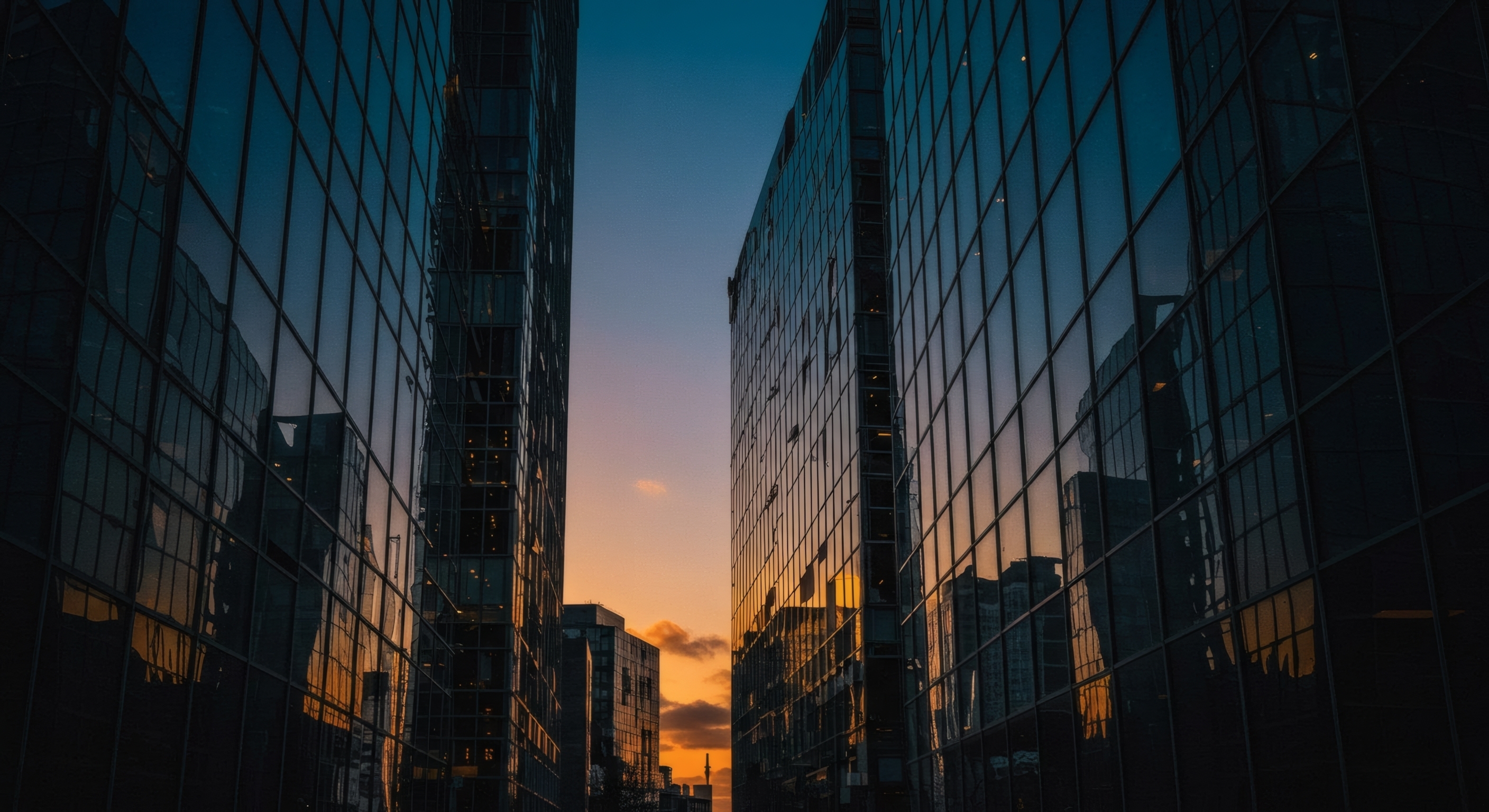 two,glass,buildings,at,sunset.,the,space,between,the,buildings